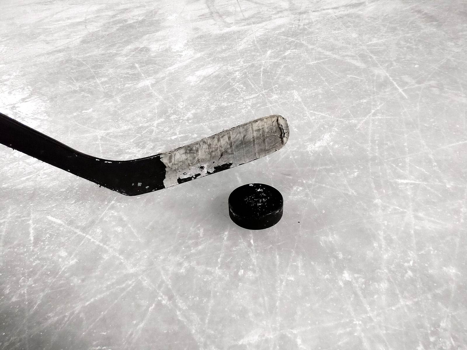 Hockey stick and puck on ice