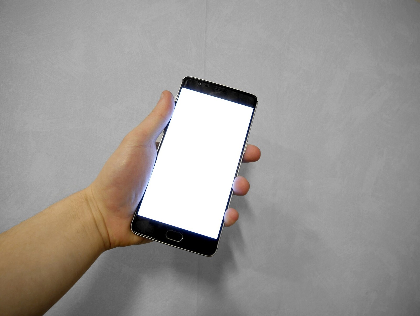 Hand holding smartphone with blank white screen.jpg